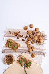 organic walnut butter and fresh nuts on table. Copy space for text. vertical photo