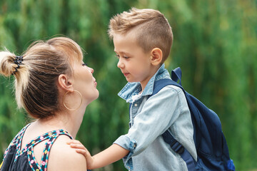 Mother seeing off her adorable little kid to school