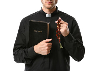 Handsome priest with Bible and rosary beads on white background