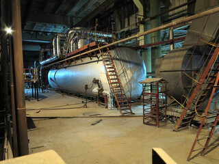 Pipes, steel tubes, steam turbine and equipment at power plant, night scene