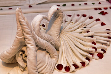Heart shape towels on the mattress 