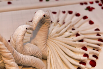 Heart shape towels on the mattress 