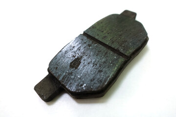 Worn out brake pad or brake shoes, component showing steel backing plates with friction material...