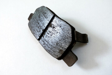 Worn out brake pad or brake shoes, component showing steel backing plates with friction material...