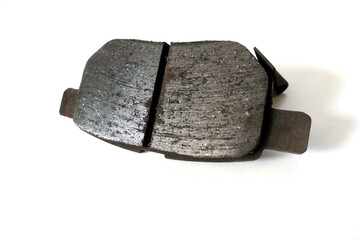 Worn out brake pad or brake shoes, component showing steel backing plates with friction material...