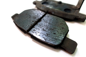 Worn out brake pad or brake shoes, component showing steel backing plates with friction material...