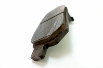 Worn out brake pad or brake shoes, component showing steel backing plates with friction material...