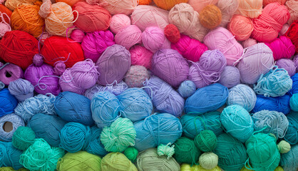 Colored balls and skiens of yarn for knitting. Top view. Rainbow colors. Color horizontal gradient.