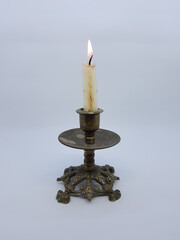 Candle in a candlestick, vintage candle holder on a white background