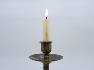 Candle in a candlestick, vintage candle holder on a white background