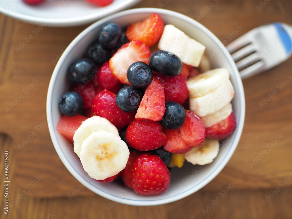 Wall mural olympus digital camera fruit salad in bowl with blueberries, strawberries and banana.