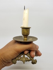 Candle in a candlestick, vintage candle holder on a white background