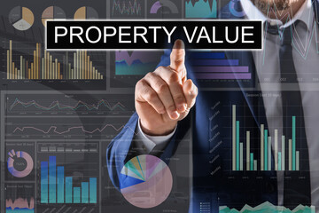 Property value concept. Businessman using virtual screen