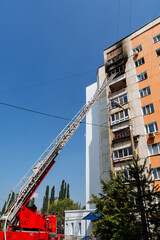 Obraz na płótnie Canvas red fire truck, fire fighting, fireman, rescue ladder ladder, burning residential multi-storey building