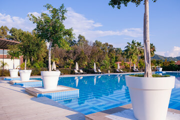 Swimming pool of luxury hotel. Full swimming pool filled with blue water. Travel concept, travelling. Hotel business.