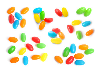 Set with delicious color jelly beans on white background, top view
