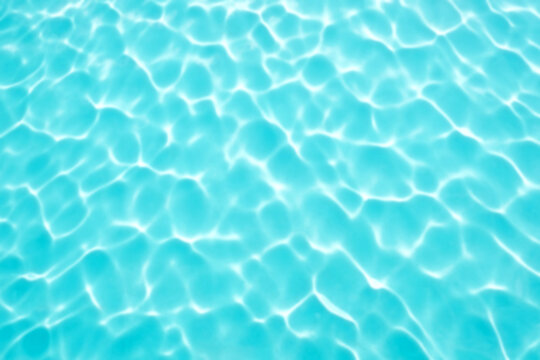 Top view of emerald water surface background in sunlight at daytime.  Sea ocean water texture. Backdrop of Crystal clear water in pool. Abstract aqua surface pattern. Design wallpaper with copy space