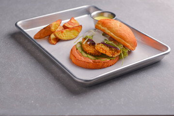 Gourmet tasty steak burger with fries. Juicy delicious craft burger with spices and baked potatoes.