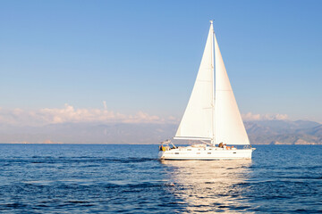 Racing yacht in the sea on blue sky background. Peaceful seascape. Travel concept, travelling.
