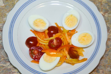 simple food on a light plate - vegetables, bell peppers and eggs