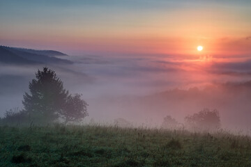 beautiful landscape with valleys, lakes and rivers in fog under High Tatras