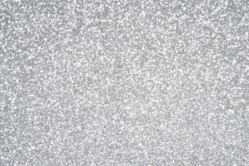 Silver Sparkling Lights Festive background with texture. Abstract Christmas twinkled bright bokeh defocused and Falling stars. Winter Card or invitation	