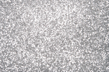 Silver Sparkling Lights Festive background with texture. Abstract Christmas twinkled bright bokeh defocused and Falling stars. Winter Card or invitation	