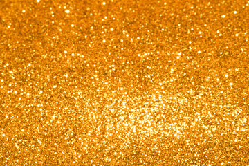 gold Sparkling Lights Festive background with texture. Abstract Christmas twinkled bright bokeh...