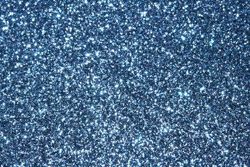 blue Sparkling Lights Festive background with texture. Abstract Christmas twinkled bright bokeh defocused and Falling stars. Winter Card or invitation	