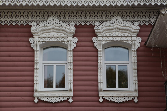 Richly decorated ornamental carved windows, frames on vintage rural house in Myshkin town, Yaroslavl region, Russia. Russian traditional national folk style in wooden architecture. Myshkin landmark