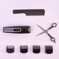 Hairdresser tools on wooden background. Haircut accessories concept. Top view