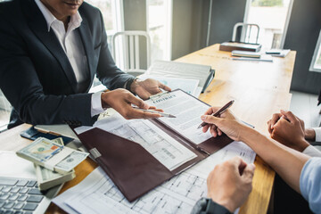 Customer signing contract documents for realty purchase, Bank employees congratulate, Concept...