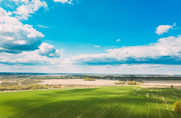 Aerial View. Sky With Clouds Above Countryside Rural Field Landscape In Spring Summer Cloudy Day. Scenic Sky With Fluffy Clouds On Horizon. Beauty In Nature