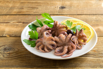 Seafood. pickled baby octopus with lemon.