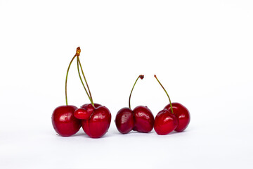Obraz na płótnie Canvas group of red fused cherries isolated on white background, ugly food concept, GMO