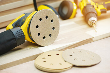 random orbit sanders, sanding machine tool on Walnut Plywood in workshop, woodworking Handicraft...