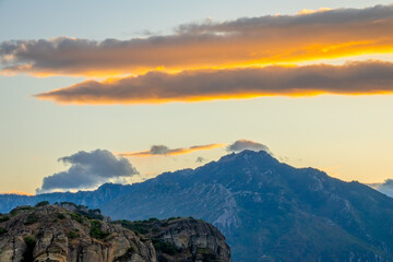 Fototapeta na wymiar Golden Post-Sunset Sky and Mountain Peaks