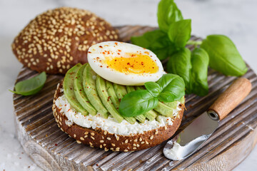 Healthy breakfast. Sandwich with avocado, egg and cream cheese. Selective focus