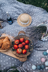 Picnic in the summer field with vegetables, fruits, croissants