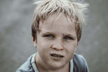 Toned portrait like poor sad homeless beggar dirty boy child made for concept as humble earth...