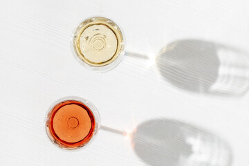 Rose and white wine in glass, top view