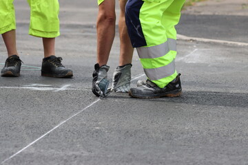 Preliminary marking with chalk. Thermoplastic road marking process.  Pedestrian crossing...