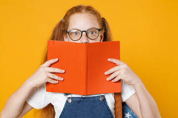 Young redhead girl 12-13 years old in white t-shirt denim uniform eyeglasses backpack hold school...