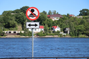 No Swimming allowed sign on the metal post