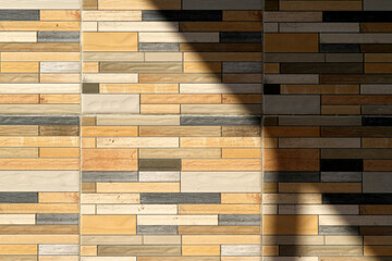 Pattern of decorative stone wall background in the morning with sun light. Part of a stone wall for background or texture. Stone wall as a background or texture