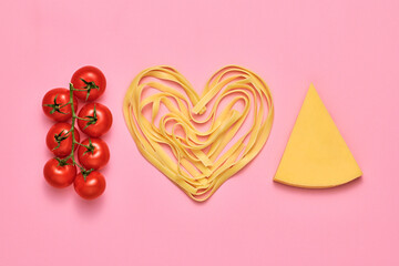 Fototapeta premium Tomato, parmesan cheese, pasta. Vegan food, creative composition on pink. Fresh red cherry tomatoes, cheese layout, pasta heart. Cooking. Italian pasta love concept, top view.
