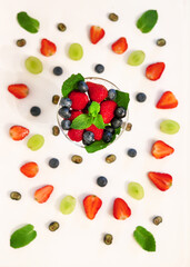composition with berries and berry mixture in a crystal glass with strawberries, blueberries, blueberries and mint close-up