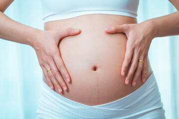 close up pregnant woman in a White underwear, posing Belly of a pregnant woman