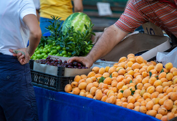 woman buying fruits from a vender