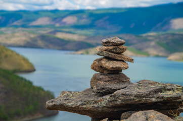 Zen concept. Object made of stone on the beach. Stone pyramid for meditation. Harmony and Meditation. Zen stones.